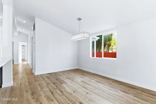 a kitchen with stainless steel appliances a refrigerator and a stove top oven