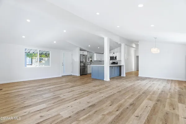 a kitchen with stainless steel appliances a sink a stove a refrigerator cabinets and a counter top space
