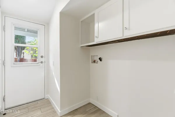 a view of a room with wooden floor and cabinet