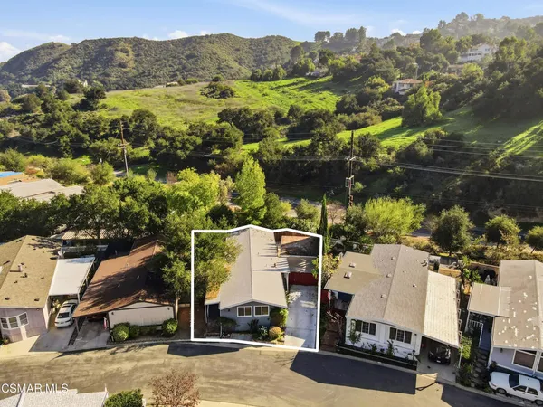 an aerial view of a houses with yard