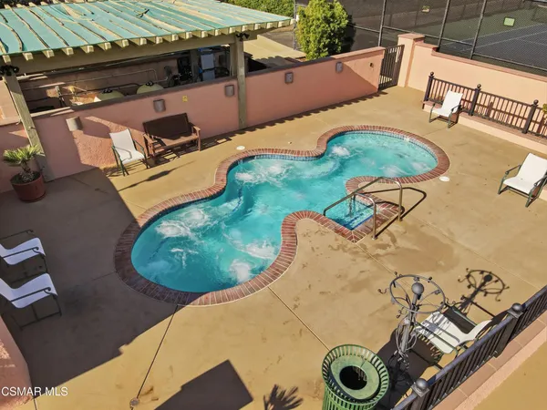 an aerial view of a residential houses with outdoor space