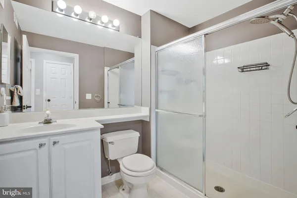 a bathroom with a sink toilet a mirror and shower