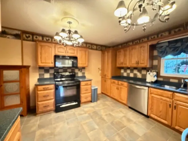 a kitchen with a stove a sink and a refrigerator
