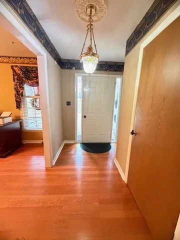 a view of entryway with a window and wooden floor