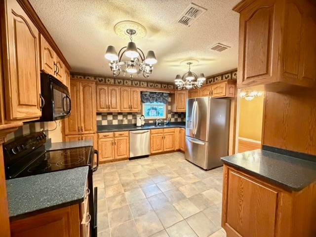 43 Liberty Road Winchester, TN 37398 - Photo 10 of 27 a kitchen with granite countertop a refrigerator a stove top oven a sink a dining table and chairs