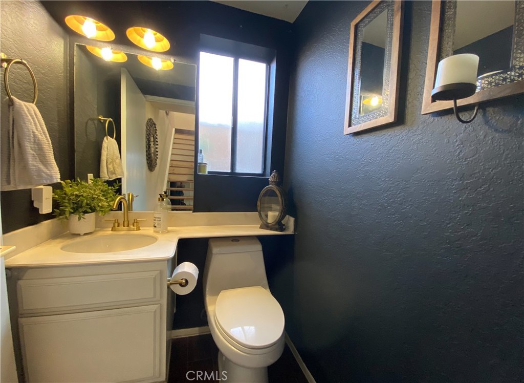 1087 Mesa Bluff Drive Costa Mesa, CA 92627 - Photo 13 of 23 a bathroom with a toilet sink and mirror