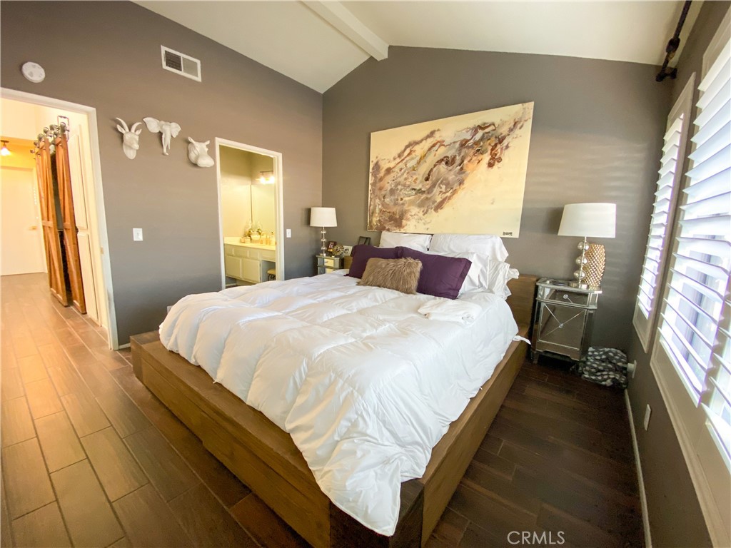 1087 Mesa Bluff Drive Costa Mesa, CA 92627 - Photo 17 of 23 a bedroom with a bed and a painting on the wall