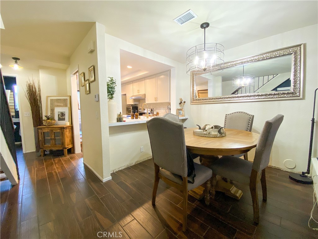 1087 Mesa Bluff Drive Costa Mesa, CA 92627 - Photo 6 of 23 a view of a dining room with furniture window and wooden floor