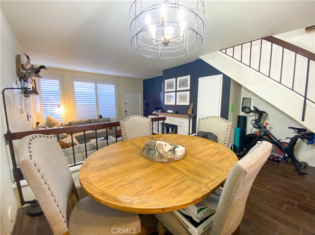 1087 Mesa Bluff Drive Costa Mesa, CA 92627 - Photo 7 of 23 a view of a dining room with furniture a chandelier and wooden floor