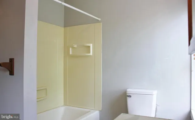 a bathroom with a shower and a toilet