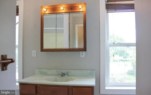 a bathroom with a sink and a mirror