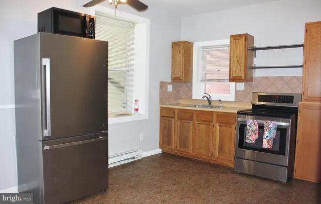 a kitchen with stainless steel appliances a refrigerator and a stove