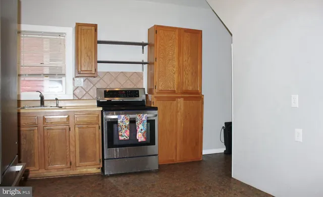 a kitchen with a refrigerator and a stove