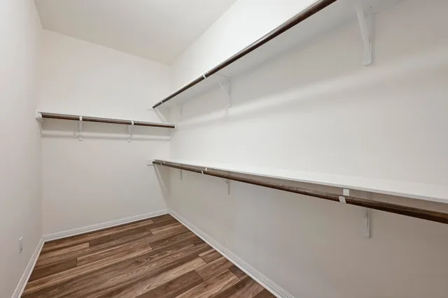 a view of a room with wooden floor