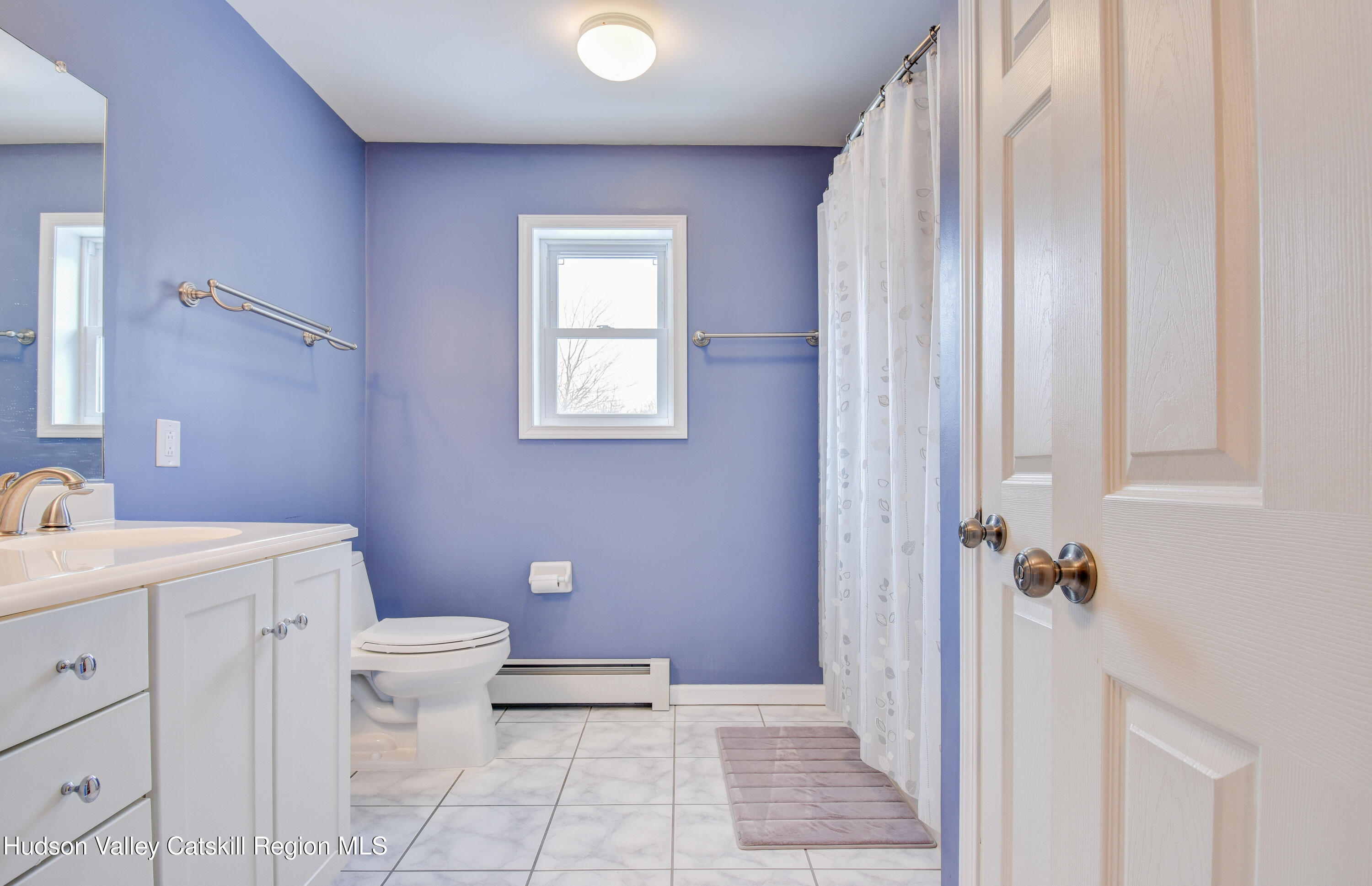 309 Quannacut Road Pine Bush, NY 12566 - Photo 11 of 43 a bathroom with a sink a toilet a window and vanity