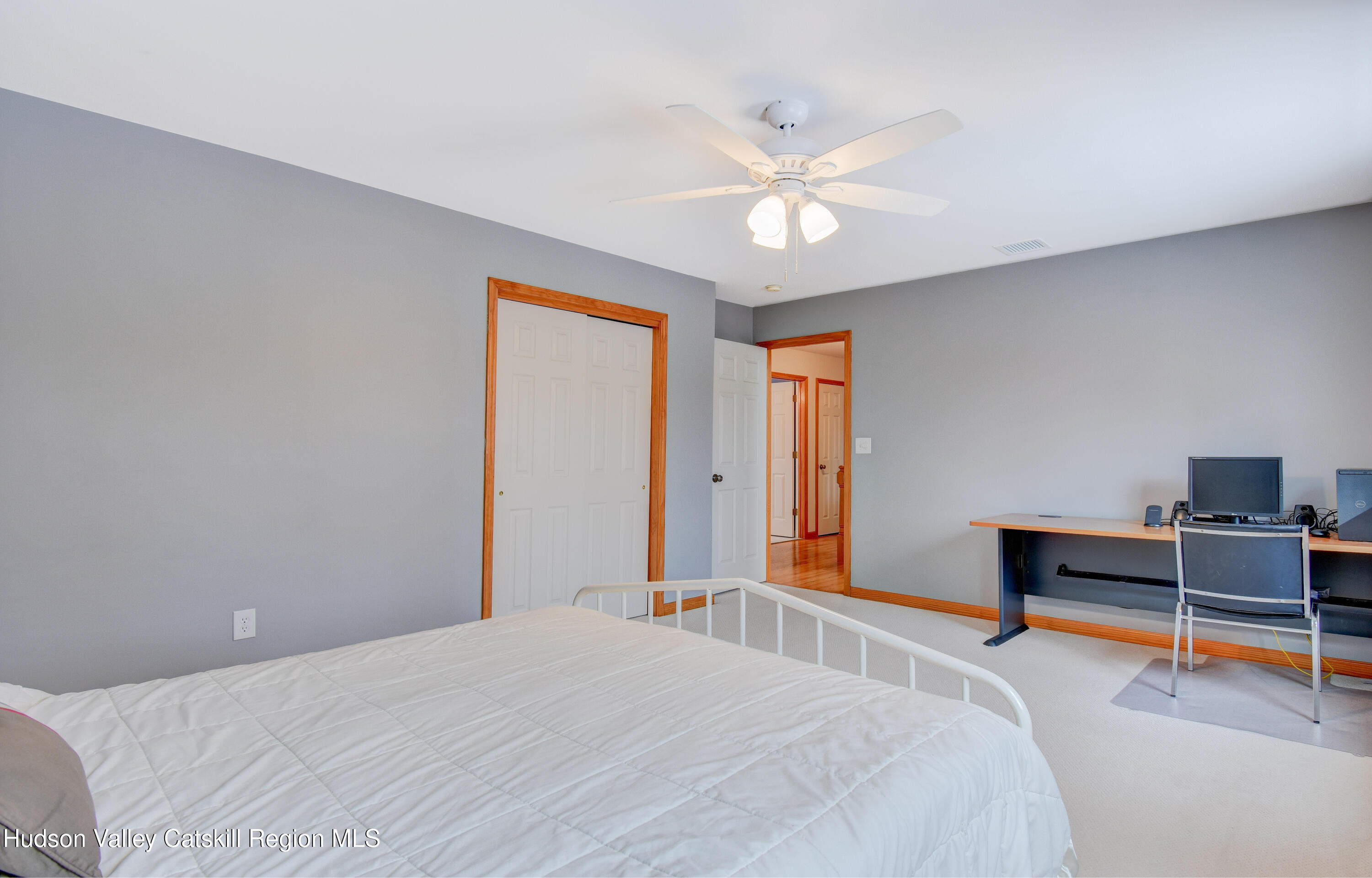 309 Quannacut Road Pine Bush, NY 12566 - Photo 14 of 43 a bedroom with a bed and a chandelier
