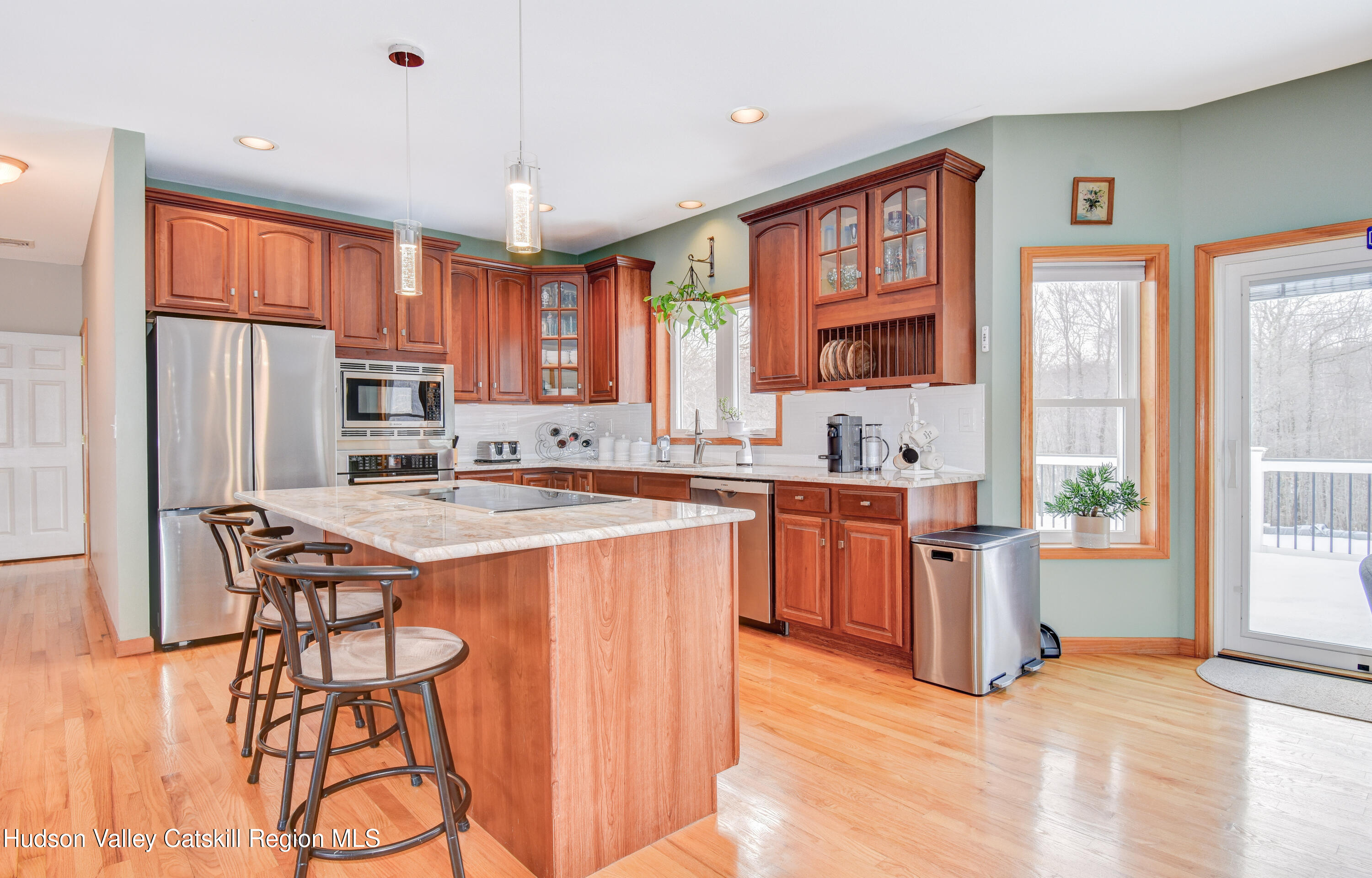 309 Quannacut Road Pine Bush, NY 12566 - Photo 38 of 43 a kitchen with stainless steel appliances granite countertop a refrigerator a sink dishwasher a stove and a dining table with wooden floor