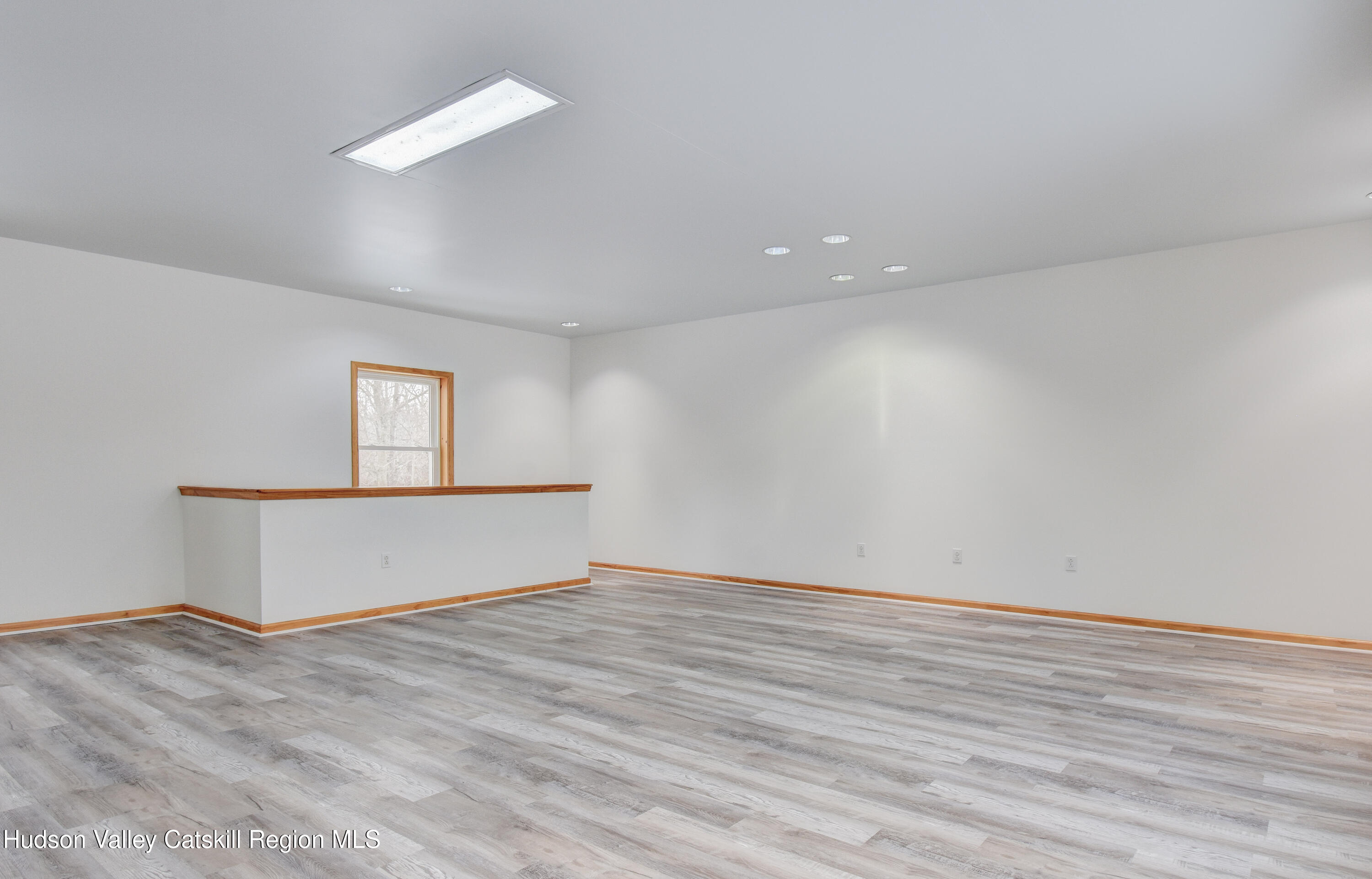 309 Quannacut Road Pine Bush, NY 12566 - Photo 7 of 43 a view of an empty room with wooden floor and a window