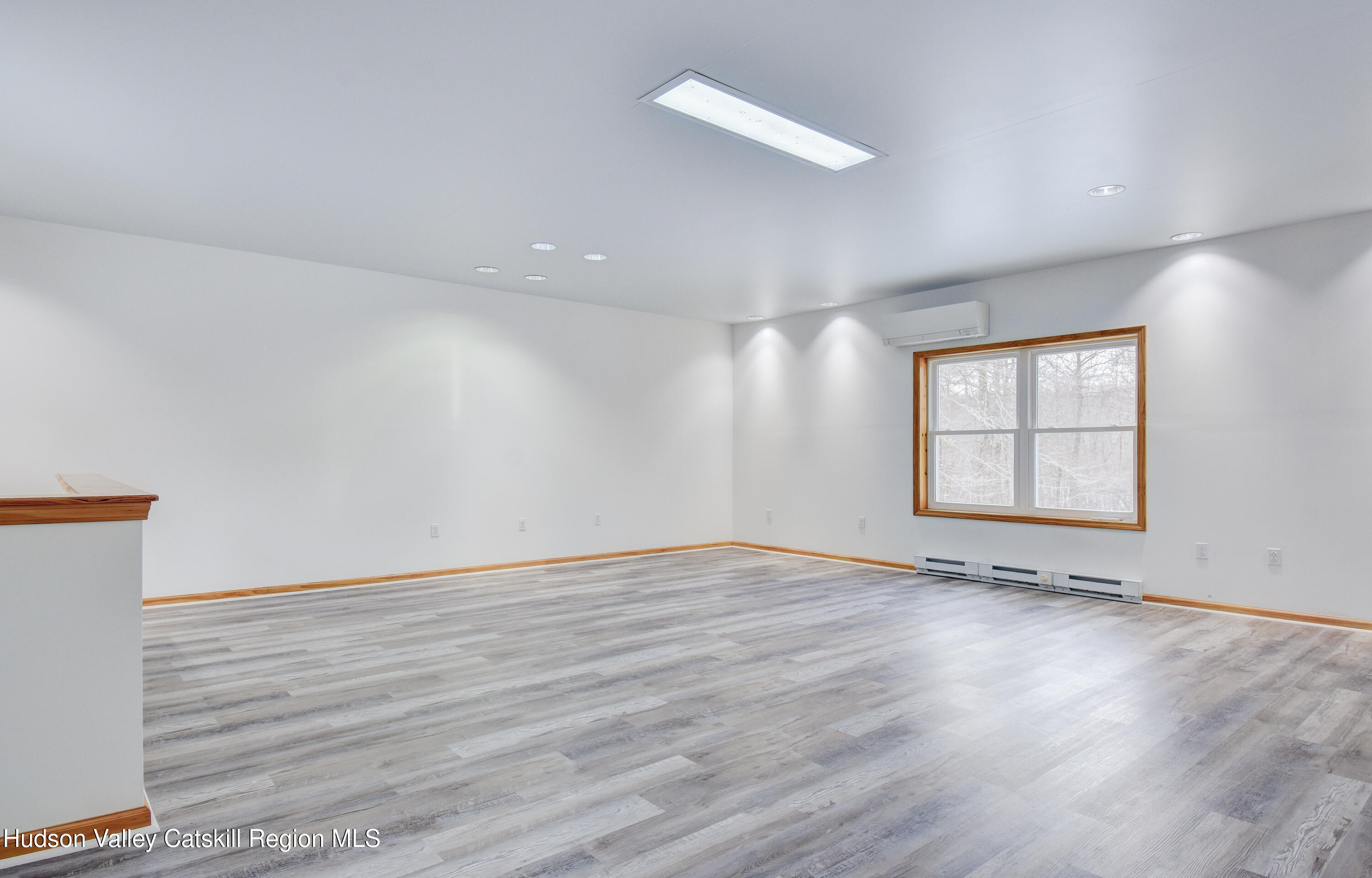 309 Quannacut Road Pine Bush, NY 12566 - Photo 8 of 43 an empty room with wooden floor and windows