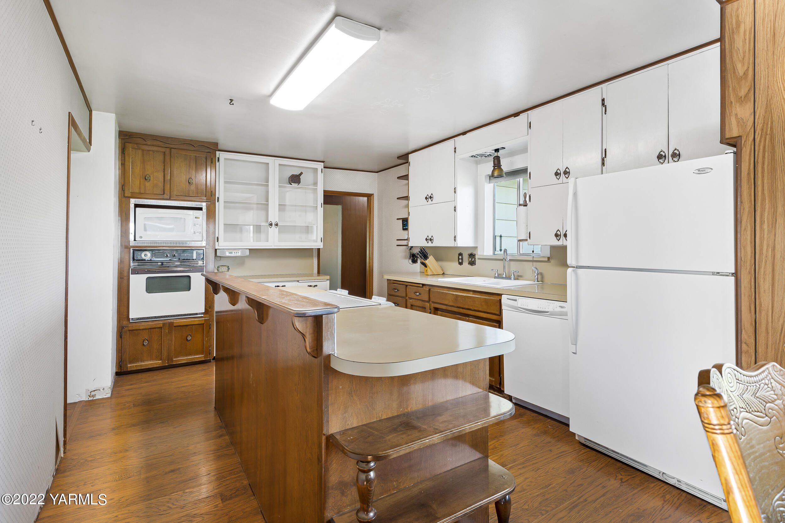 2270 Hudson Road Outlook, WA 98938 - Photo 6 of 36 a kitchen with refrigerator cabinets and wooden floor