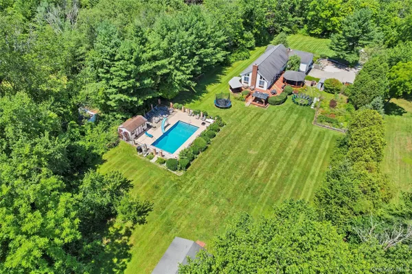 an aerial view of a house with a yard