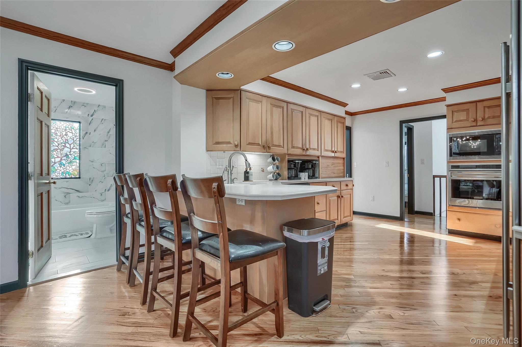 283 Prospect Road Monroe, NY 10950 - Photo 16 of 26 a kitchen with stainless steel appliances kitchen island granite countertop a refrigerator a stove a sink a dining table and chairs with wooden floor