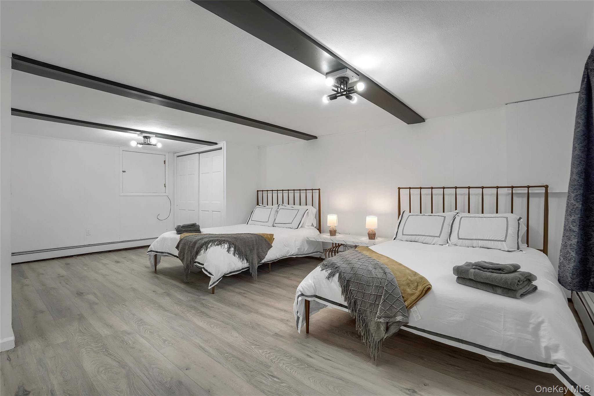 283 Prospect Road Monroe, NY 10950 - Photo 21 of 26 a bedroom with bed and a chandelier