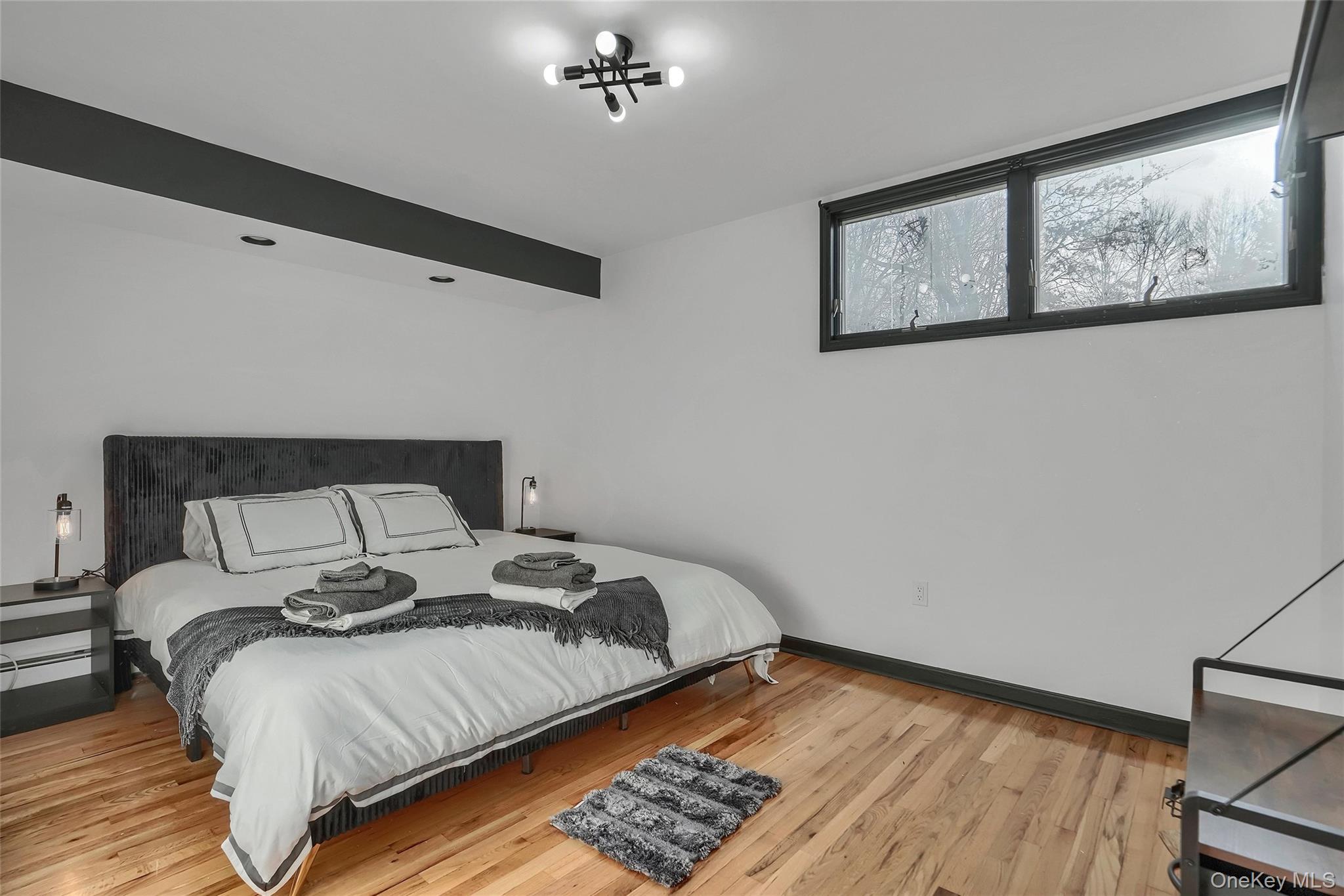 283 Prospect Road Monroe, NY 10950 - Photo 24 of 26 a bedroom with a bed and wooden floor