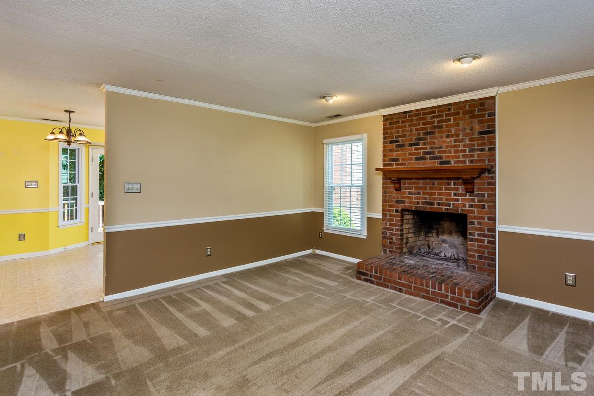6908 Sandringham Drive Raleigh, NC 27613 - Photo 2 of 21 a view of livingroom with fireplace and window