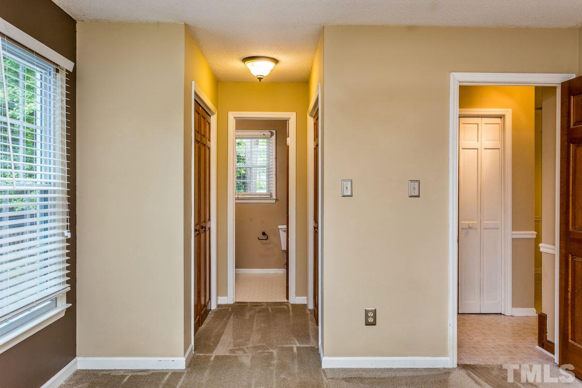 6908 Sandringham Drive Raleigh, NC 27613 - Photo 11 of 21 a view of a bathroom with a glass door and a window