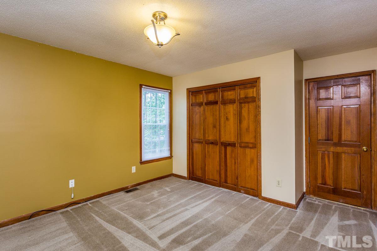 6908 Sandringham Drive Raleigh, NC 27613 - Photo 14 of 21 a view of an empty room with a window