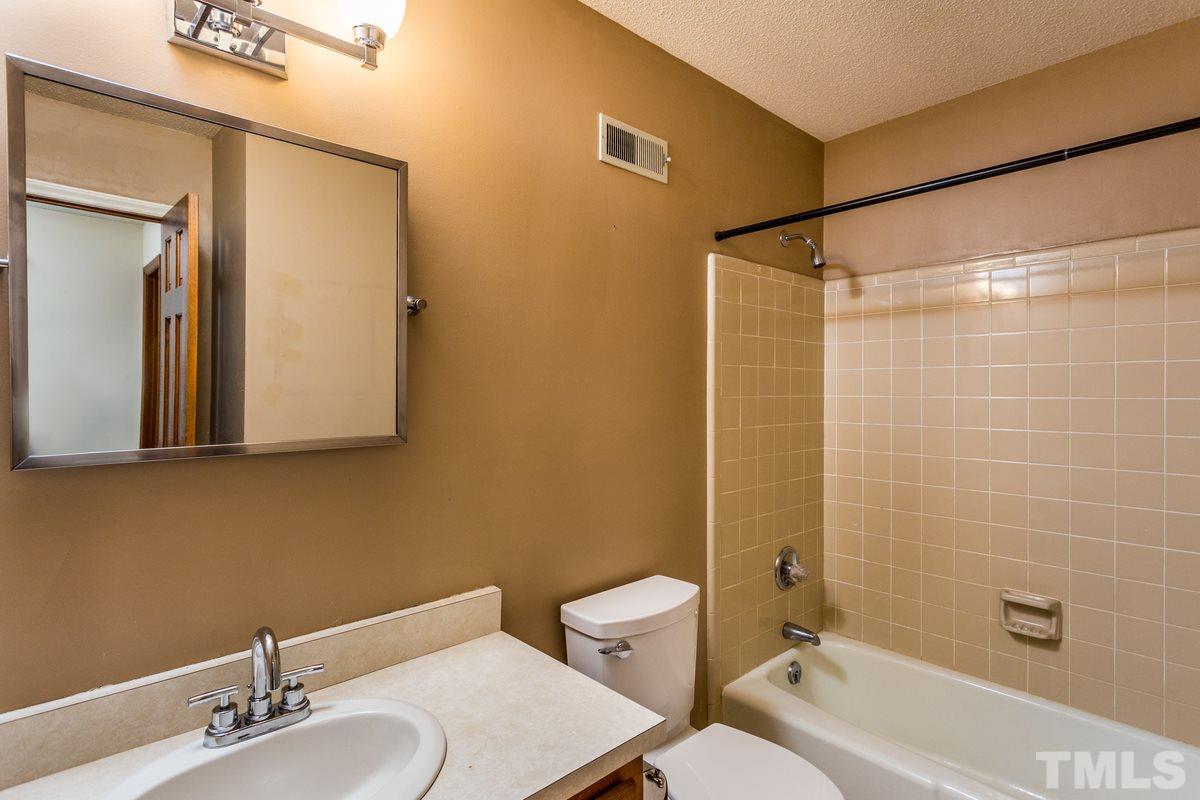 6908 Sandringham Drive Raleigh, NC 27613 - Photo 17 of 21 a bathroom with a sink and a mirror