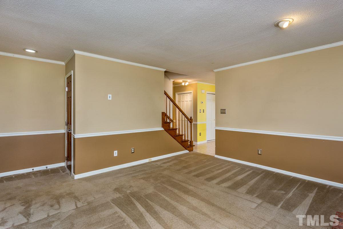 6908 Sandringham Drive Raleigh, NC 27613 - Photo 3 of 21 a view of an empty room with stairs