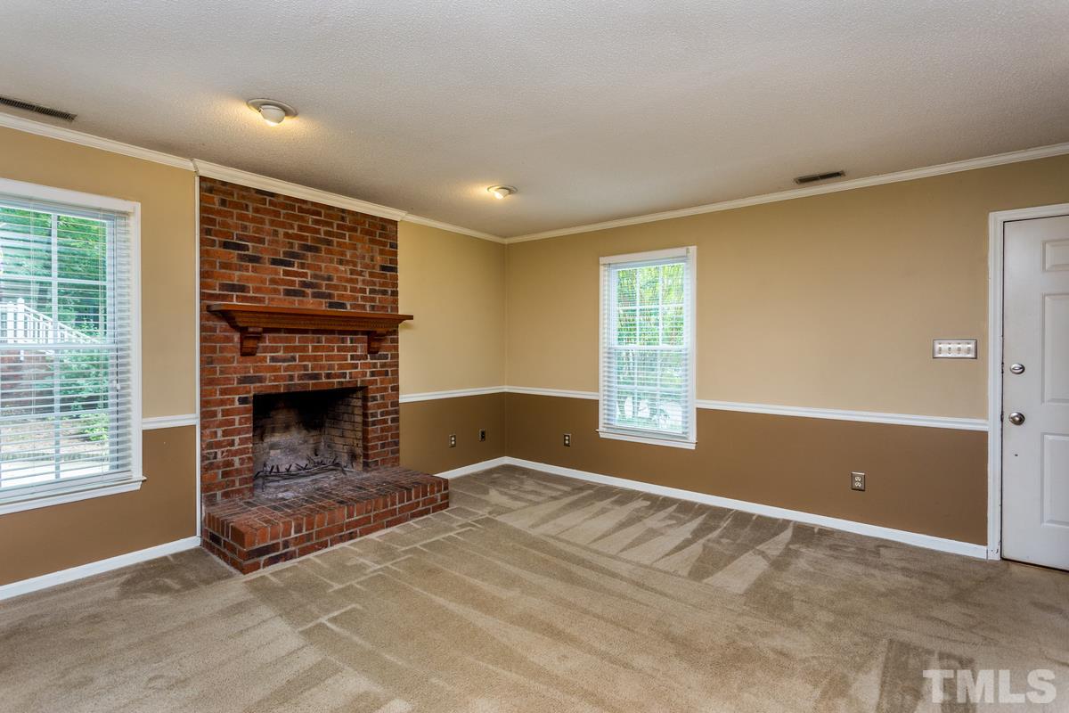 6908 Sandringham Drive Raleigh, NC 27613 - Photo 4 of 21 a view of livingroom with a fireplace