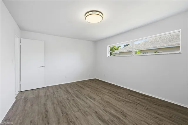 a view of a room with wooden floor