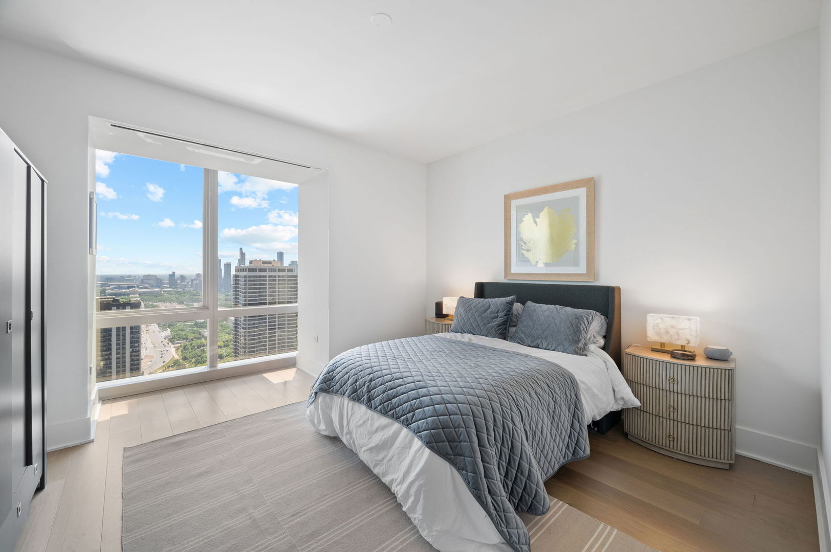 363 East Wacker Drive, Unit 3109 Chicago, IL 60601 - Photo 20 of 23 a bedroom with a large bed and a large window