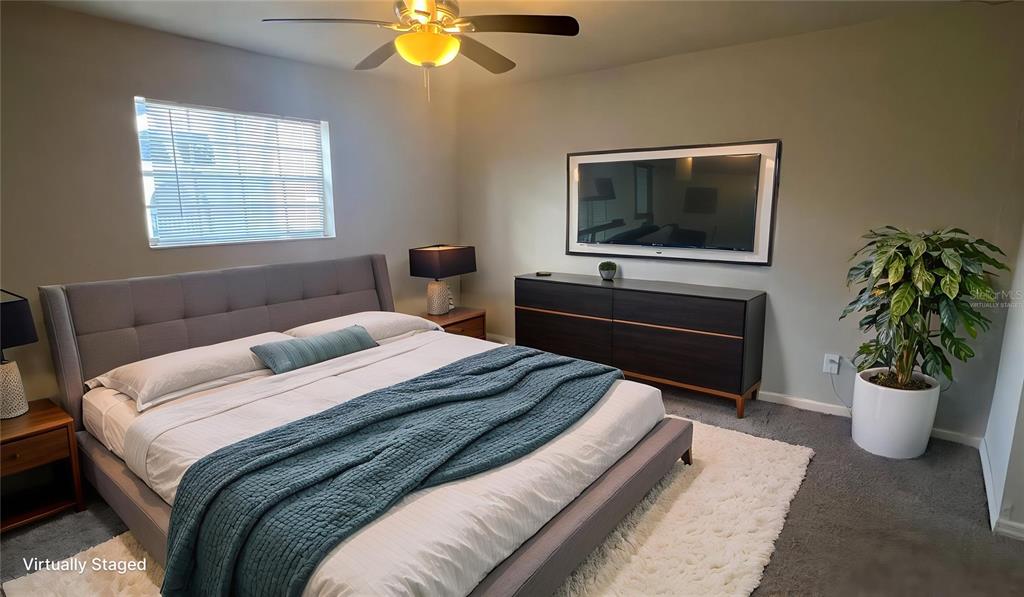 711 Russell Lane, Unit 134 Brandon, FL 33510 - Photo 12 of 24 a bedroom with a bed and a flat screen tv