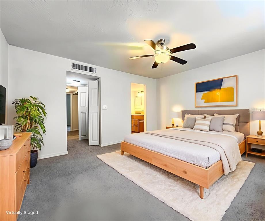 711 Russell Lane, Unit 134 Brandon, FL 33510 - Photo 14 of 24 a spacious bedroom with a bed and a chandelier