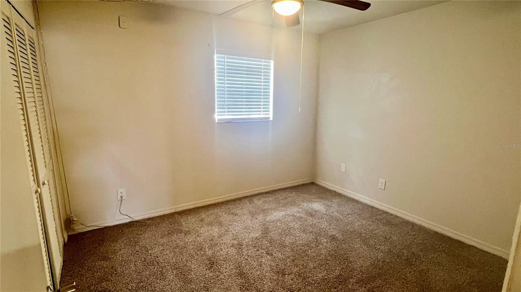 711 Russell Lane, Unit 134 Brandon, FL 33510 - Photo 19 of 24 an empty room with windows and chandelier fan