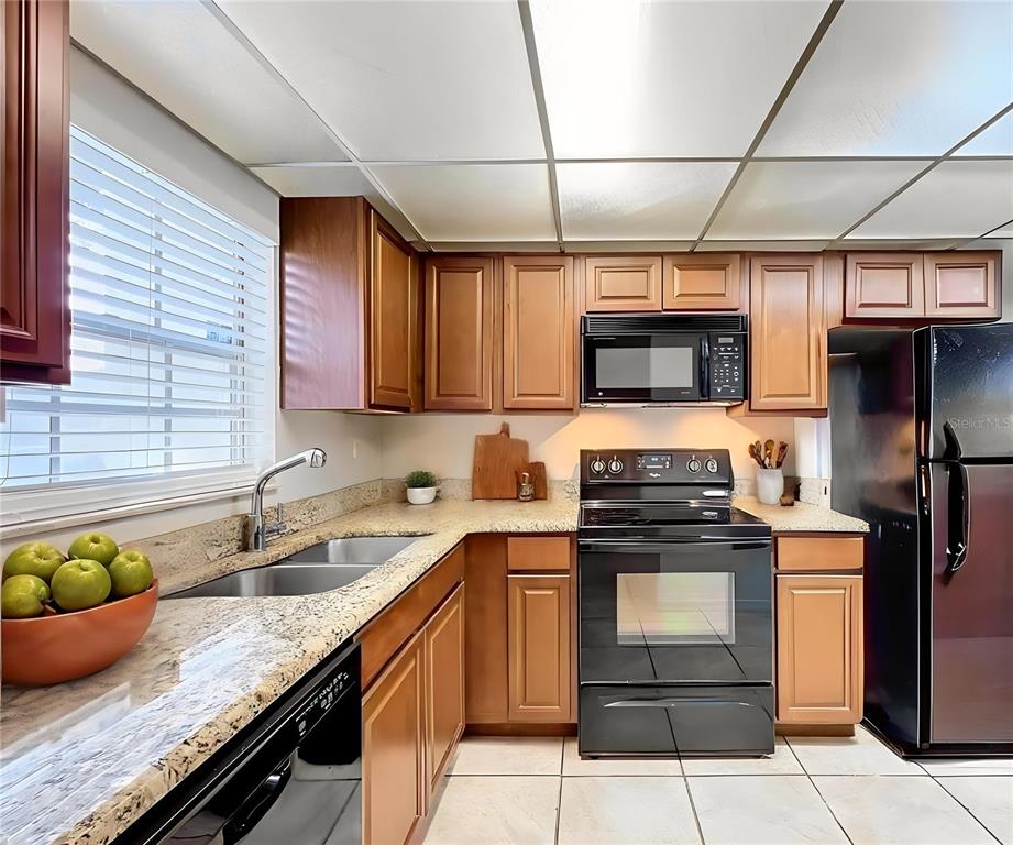 711 Russell Lane, Unit 134 Brandon, FL 33510 - Photo 4 of 24 a kitchen with stainless steel appliances granite countertop a sink a stove and a counter space