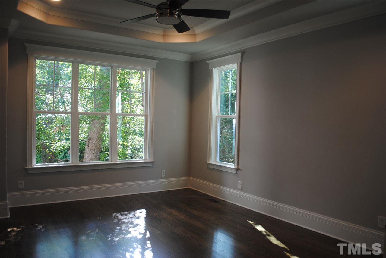 1220 Mitchell Street Raleigh, NC 27607 - Photo 11 of 25 a view of an empty room with wooden floor and a window