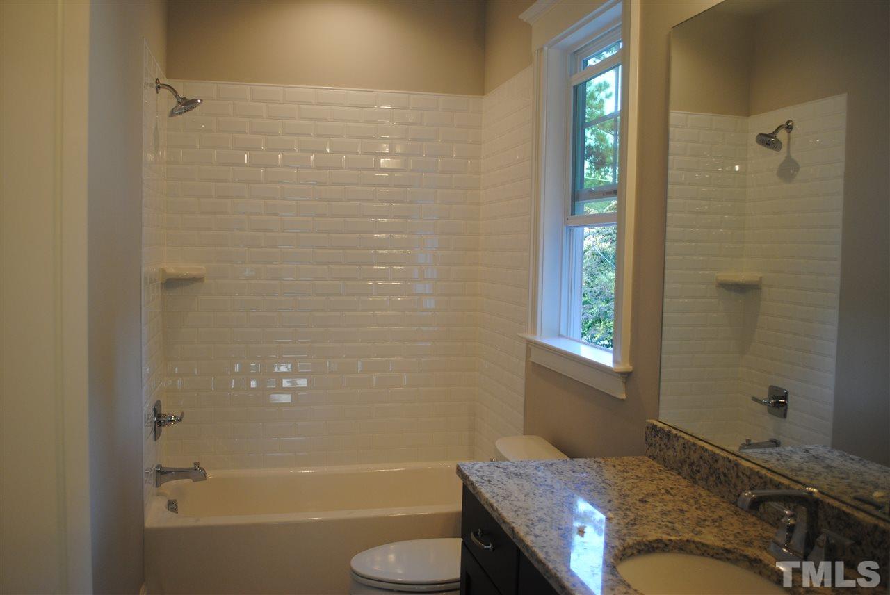 1220 Mitchell Street Raleigh, NC 27607 - Photo 15 of 25 a bathroom with a granite countertop bathtub sink vanity mirror and toilet