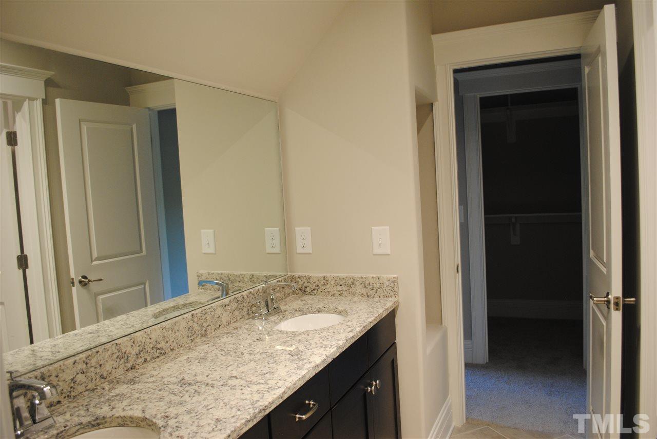 1220 Mitchell Street Raleigh, NC 27607 - Photo 17 of 25 a bathroom with a granite countertop sink and a mirror