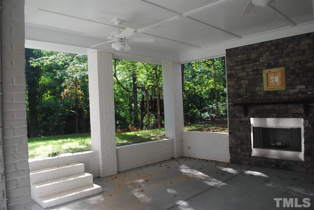 1220 Mitchell Street Raleigh, NC 27607 - Photo 20 of 25 a living room with a fireplace and a floor to ceiling window