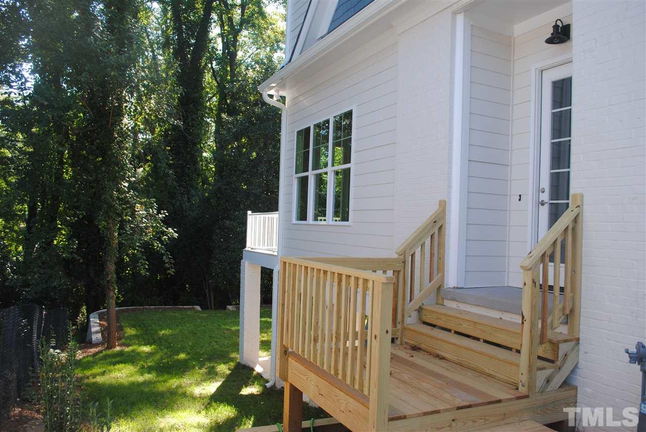 1220 Mitchell Street Raleigh, NC 27607 - Photo 22 of 25 a view of front door of house with yard