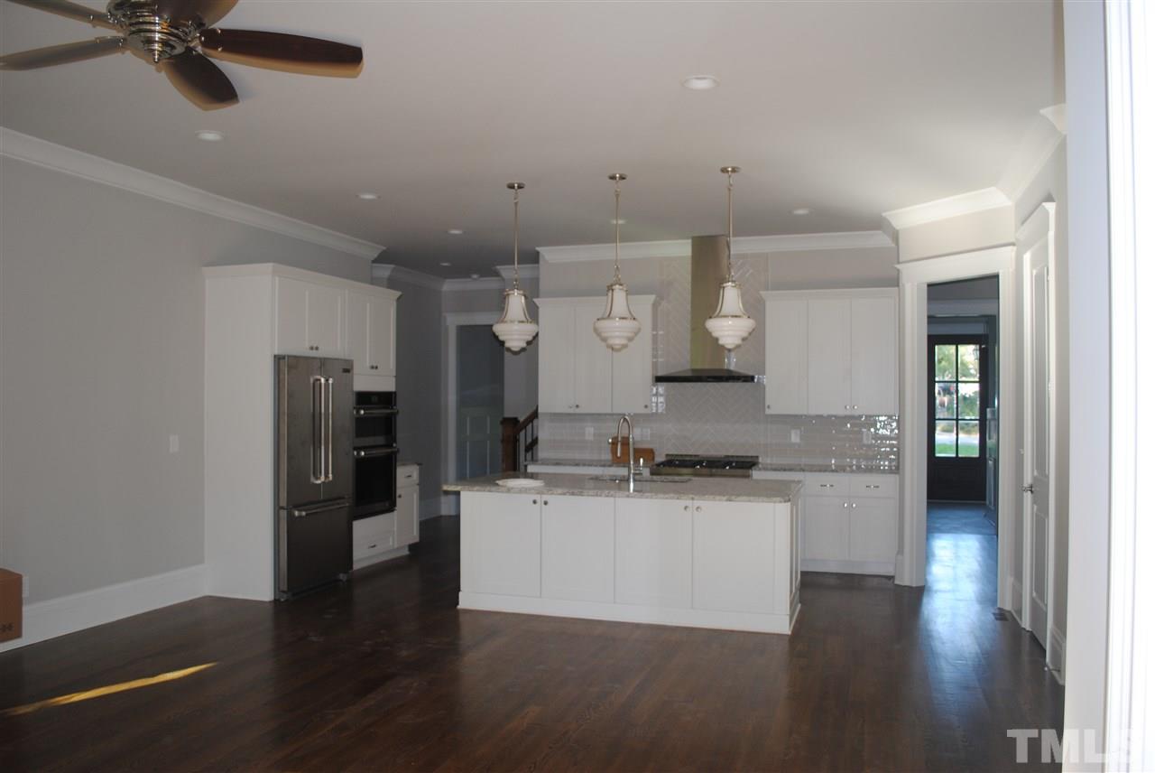 1220 Mitchell Street Raleigh, NC 27607 - Photo 5 of 25 a kitchen with stainless steel appliances granite countertop a refrigerator a sink dishwasher a stove and a wooden floors
