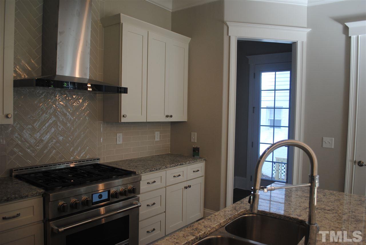 1220 Mitchell Street Raleigh, NC 27607 - Photo 6 of 25 a kitchen with granite countertop a stove a sink and a granite counter tops