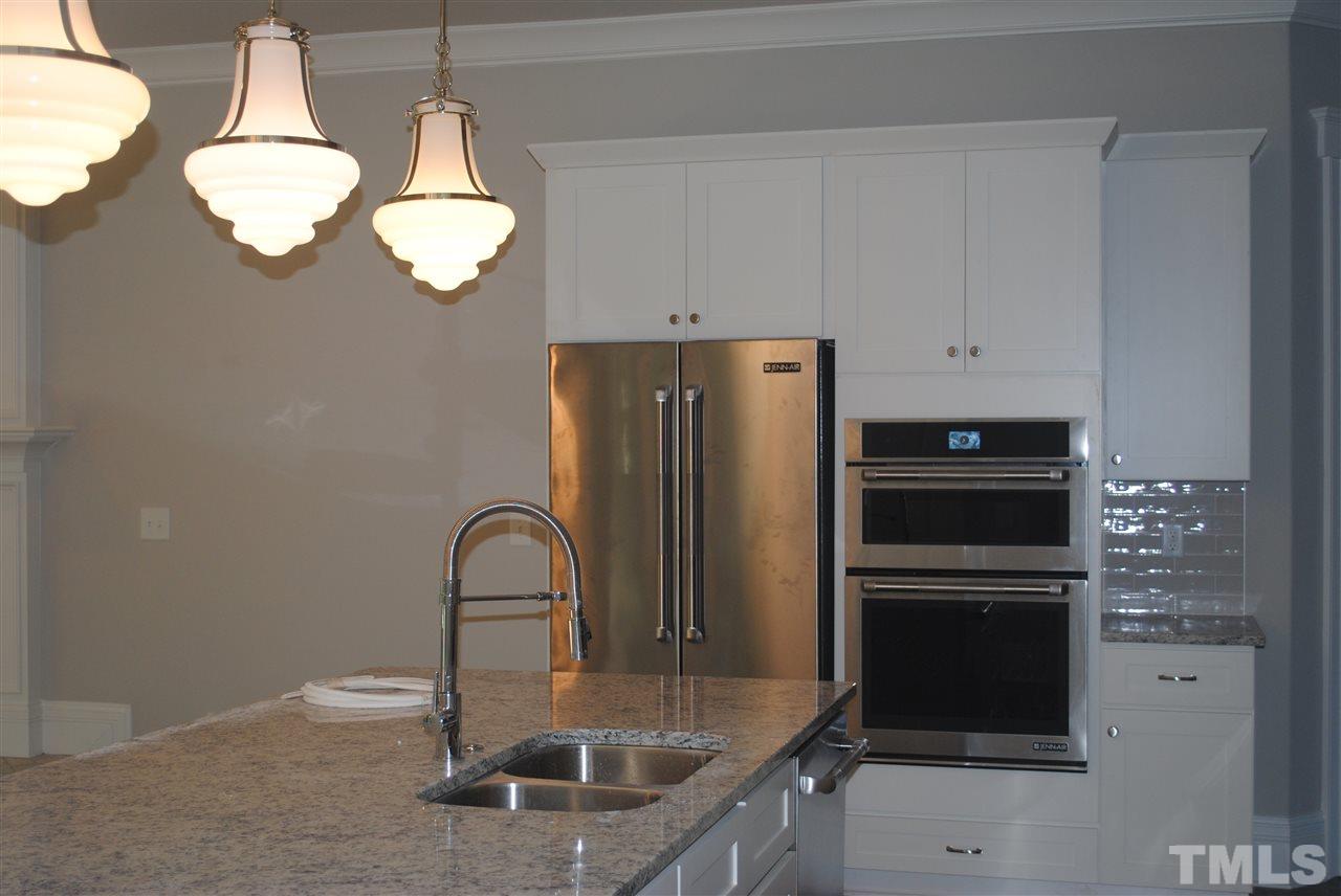 1220 Mitchell Street Raleigh, NC 27607 - Photo 8 of 25 a kitchen with stainless steel appliances granite countertop a sink and a refrigerator