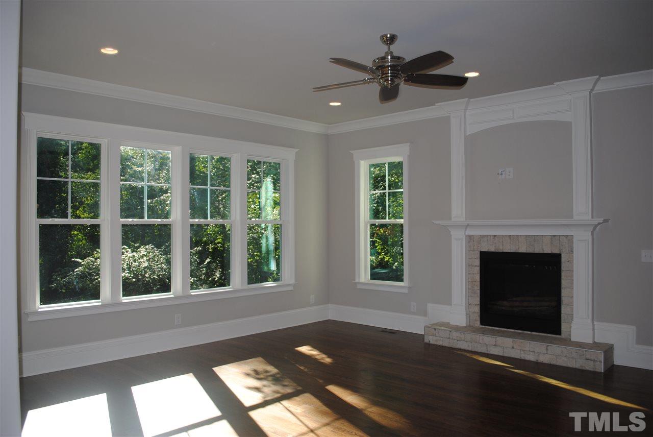1220 Mitchell Street Raleigh, NC 27607 - Photo 10 of 25 a view of an empty room with wooden floor and a window