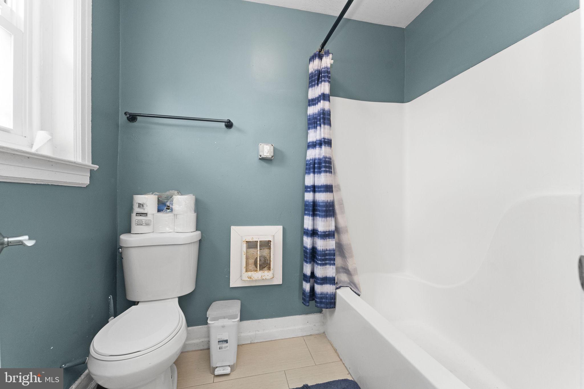 366 East Moore Street Norristown, PA 19401 - Photo 13 of 20 a white toilet sitting next to a bathroom sink and a shower